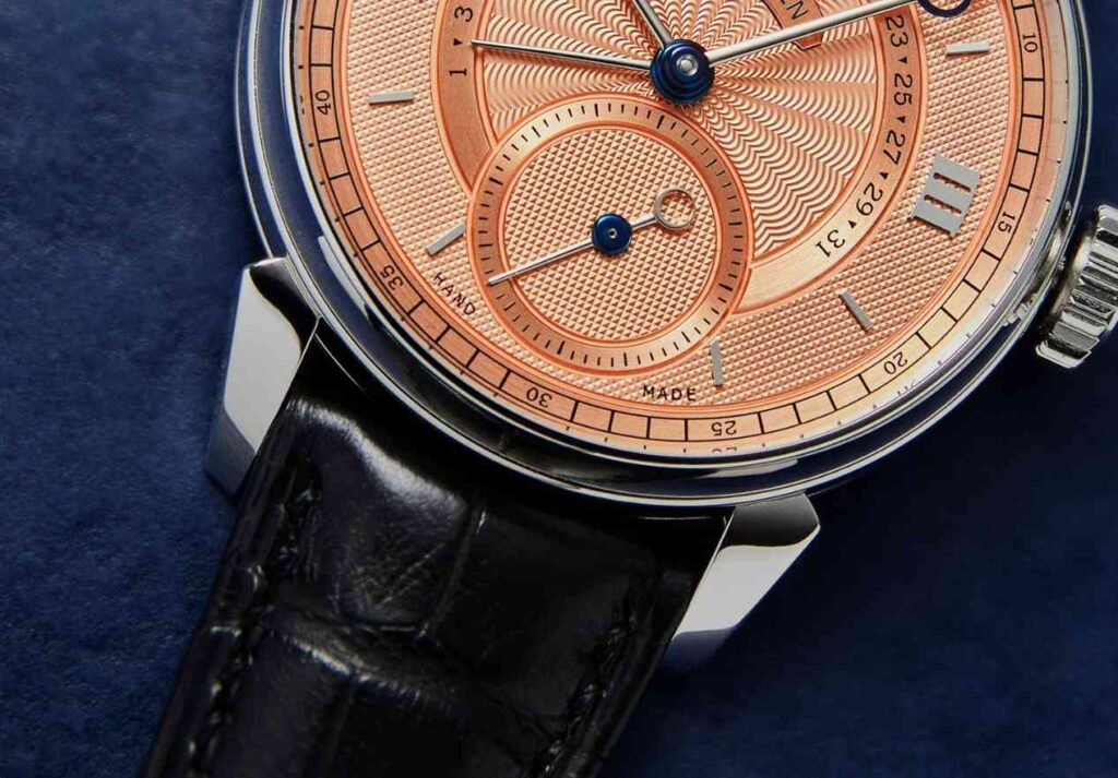 Voutilainen Vingt-8 Salmon Dial Watch with thin hands and roman numerals